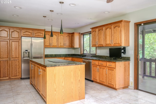 2011 SW 29th Dr, Gresham, OR 97080 - kitchen with stainless steel appliances, a kitchen island, dark stone counters, decorative light fixtures, and brown cabinetry