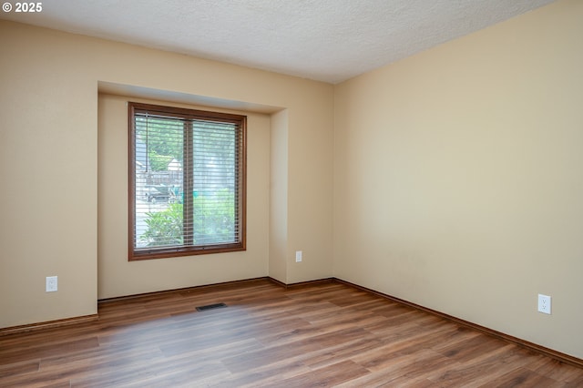 2011 SW 29th Dr, Gresham, OR 97080 - unfurnished room featuring wood finished floors and a textured ceiling