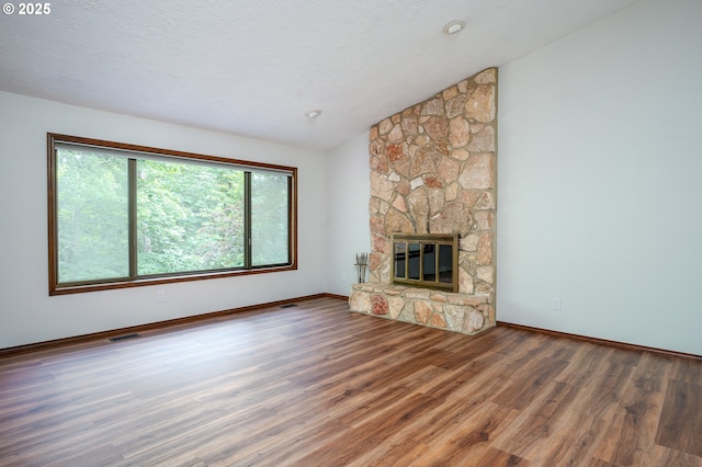 2011 SW 29th Dr, Gresham, OR 97080 - unfurnished living room with wood finished floors, vaulted ceiling, and a fireplace