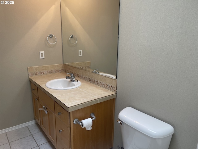 bathroom with vanity, backsplash, tile patterned flooring, and toilet