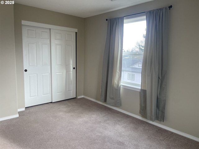 unfurnished bedroom with a closet and carpet flooring