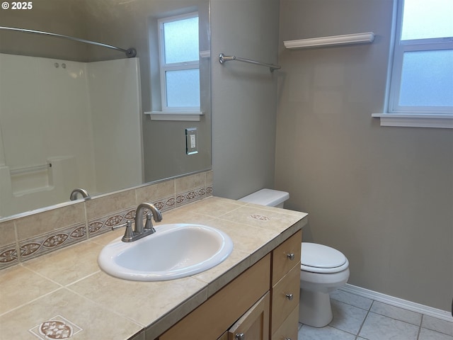 bathroom featuring vanity, tile patterned flooring, a shower, and toilet