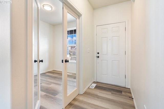 doorway featuring french doors and light hardwood / wood-style floors