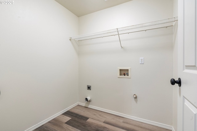 clothes washing area featuring washer hookup, hardwood / wood-style flooring, and hookup for an electric dryer