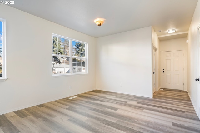 unfurnished room with light hardwood / wood-style floors