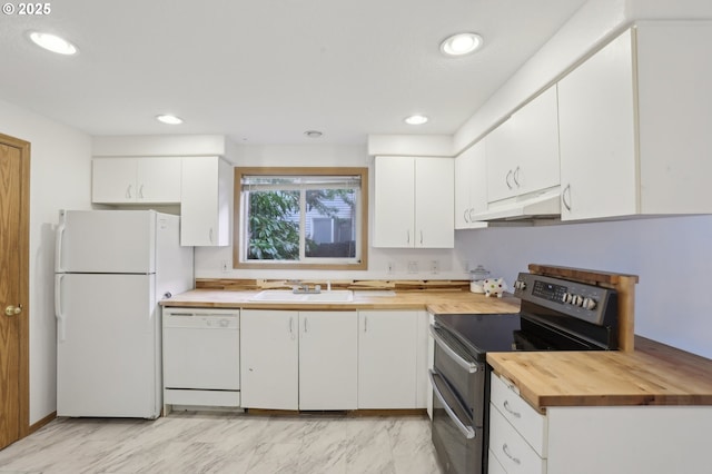 kitchen featuring butcher block counters, white appliances, under cabinet range hood, white cabinets, and a sink