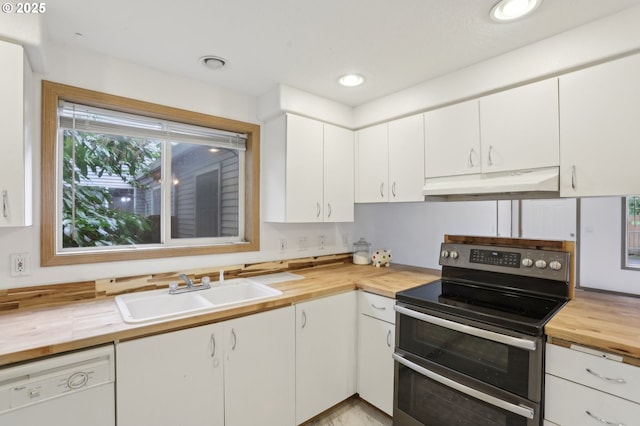kitchen featuring wooden counters, white dishwasher, under cabinet range hood, a sink, and double oven range