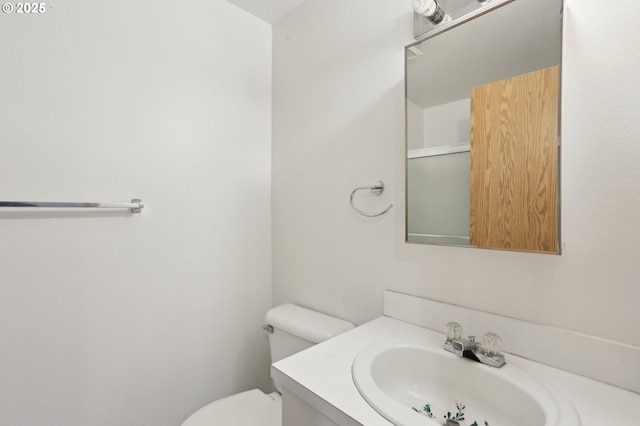 bathroom with toilet and vanity
