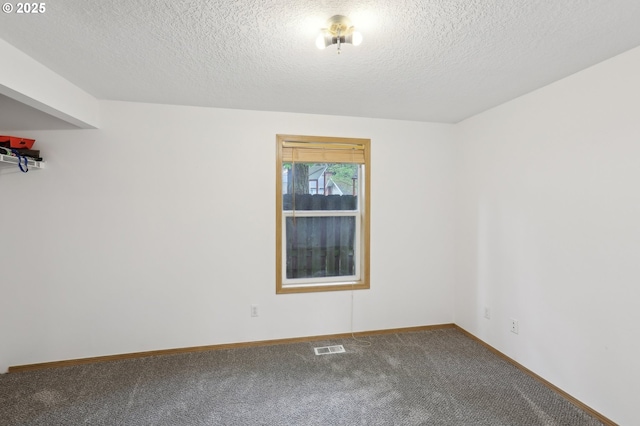 carpeted empty room with visible vents, a textured ceiling, and baseboards