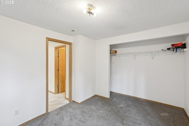 unfurnished bedroom with a closet, baseboards, carpet flooring, and a textured ceiling