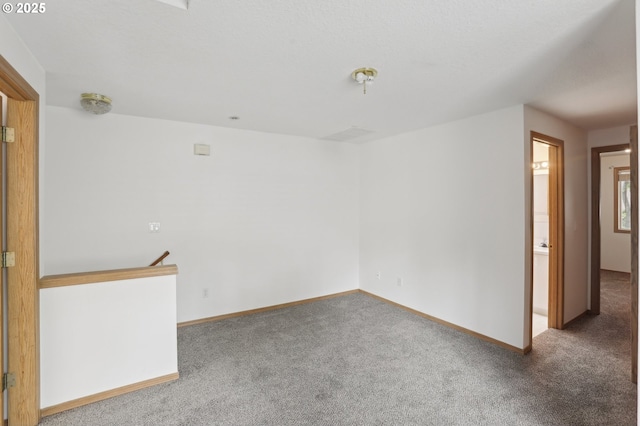 carpeted spare room with baseboards
