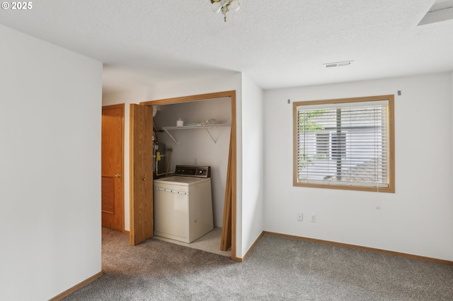 laundry room featuring laundry area, a textured ceiling, visible vents, light colored carpet, and washer / dryer