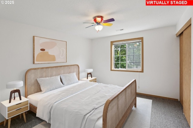 bedroom featuring visible vents, a ceiling fan, carpet, and baseboards