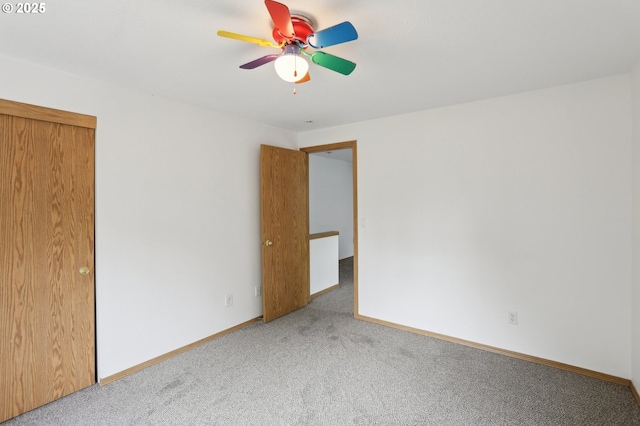 unfurnished bedroom featuring baseboards, a ceiling fan, and carpet
