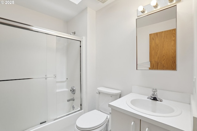full bath with toilet, enclosed tub / shower combo, and vanity