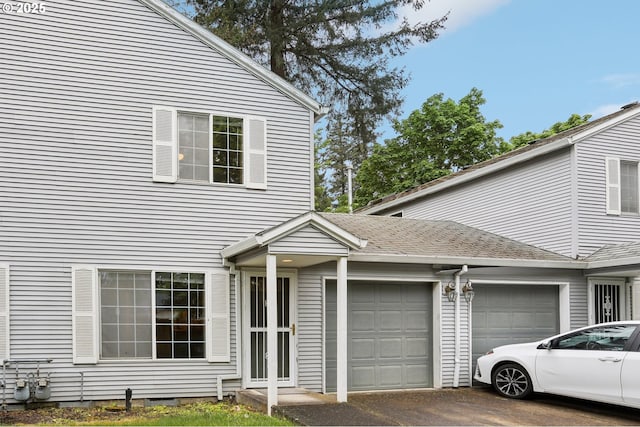 view of front of house with a garage and aphalt driveway