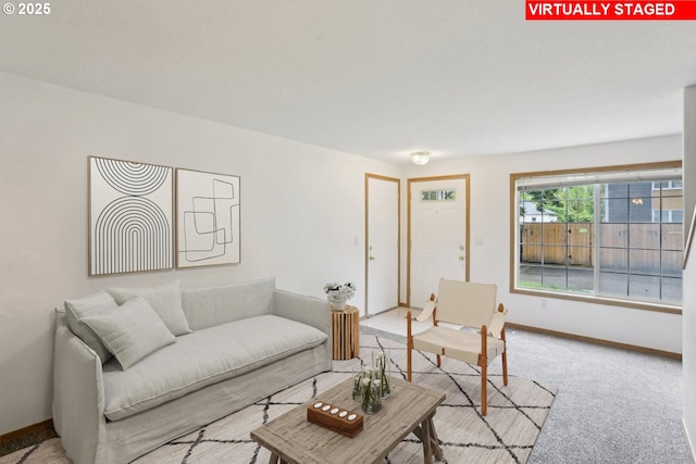 living room with baseboards and light colored carpet