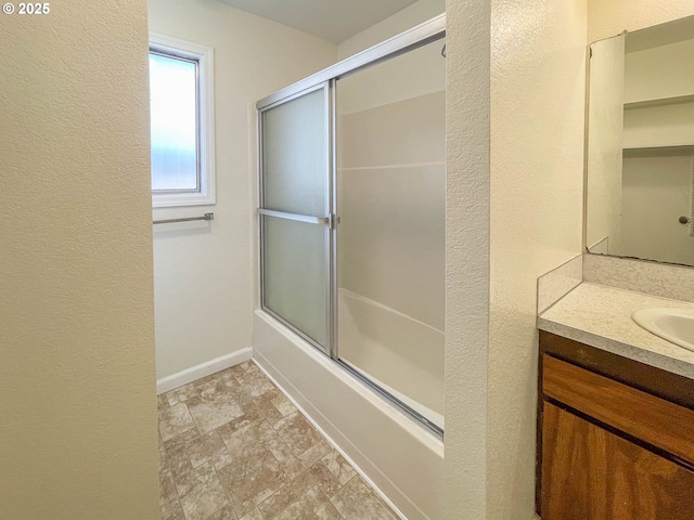 1911 Green Ave, Roseburg, OR 97471 - full bathroom featuring shower / bath combination with glass door, vanity, stone finish flooring, baseboards, and a textured wall