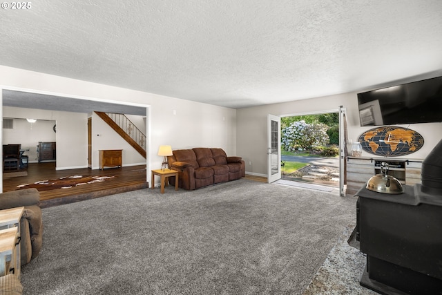 35000 SE Bell Maple Dr, Boring, OR 97009 - living area with a wood stove, carpet floors, a textured ceiling, stairs, and baseboards
