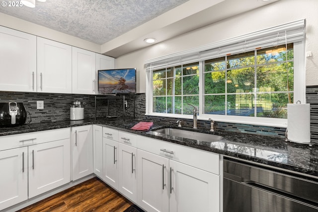 35000 SE Bell Maple Dr, Boring, OR 97009 - kitchen with dark wood-style flooring, a sink, dishwasher, white cabinetry, and decorative backsplash