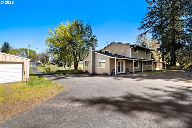 35000 SE Bell Maple Dr, Boring, OR 97009 - view of front of property featuring a chimney, a garage, french doors, and driveway