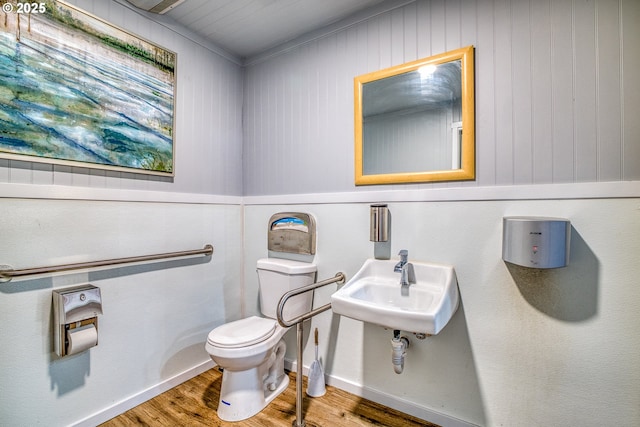 203 N Birch St, Coquille, OR 97423 - half bath with toilet, wood finished floors, a sink, wooden walls, and baseboards