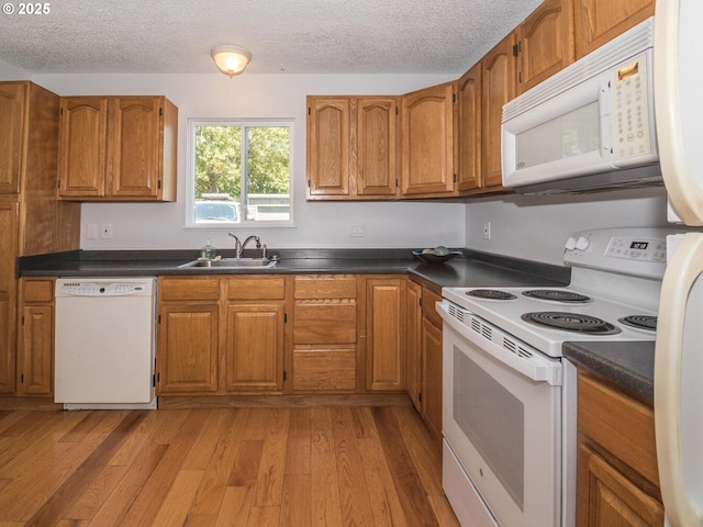 2712 SE 138th Ave Unit 53, Portland, OR 97236 - kitchen featuring white appliances, brown cabinets, and a textured ceiling