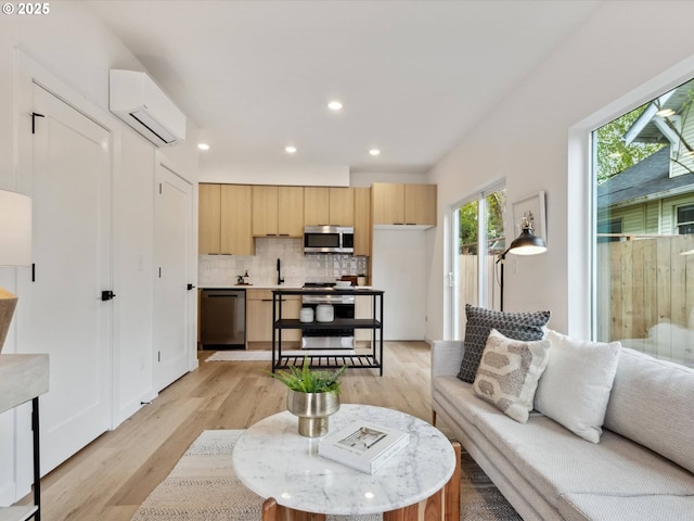 1534 N Schofield St, Portland, OR 97217 - living room with a wall mounted air conditioner, light wood-style flooring, and recessed lighting
