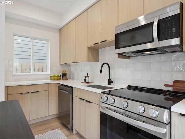 1534 N Schofield St, Portland, OR 97217 - kitchen featuring stainless steel appliances, a sink, light brown cabinetry, and light countertops