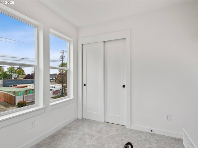 1534 N Schofield St, Portland, OR 97217 - unfurnished bedroom featuring light carpet, a closet, and baseboards