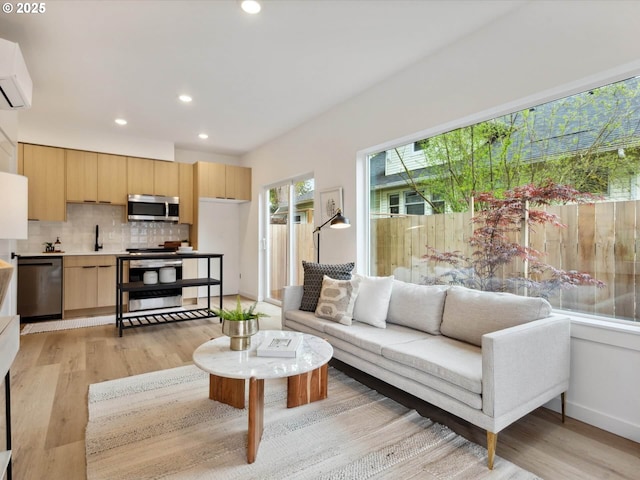 1534 N Schofield St, Portland, OR 97217 - living area featuring light wood-style floors, recessed lighting, a wall unit AC, and baseboards