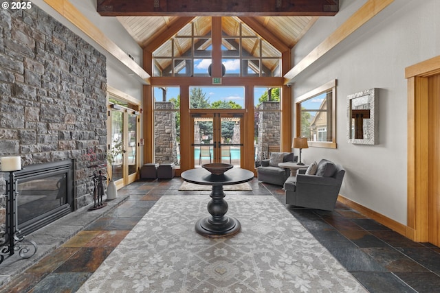 17019 SW Glen Park Ct, Beaverton, OR 97003 - living room with stone tile floors, beamed ceiling, high vaulted ceiling, a fireplace, and baseboards