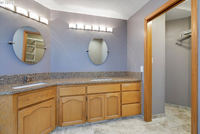 full bath with double vanity and a sink