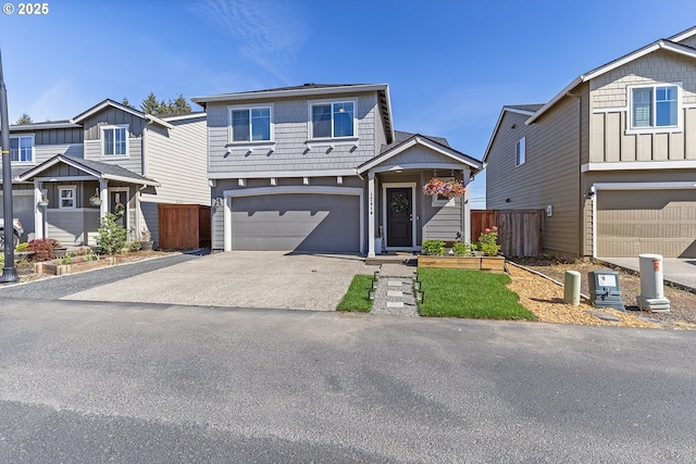 12810 NE 118th Way, Vancouver, WA 98682 - view of front facade with a garage, asphalt driveway, fence, and board and batten siding