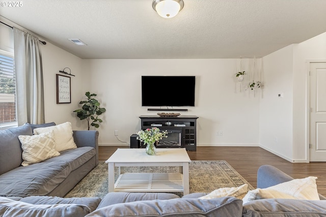 12810 NE 118th Way, Vancouver, WA 98682 - living room with dark wood finished floors, a textured ceiling, and baseboards