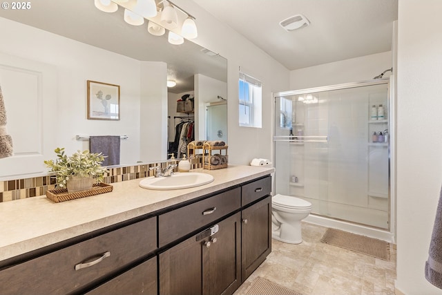 12810 NE 118th Way, Vancouver, WA 98682 - full bathroom featuring a shower stall, toilet, vanity, tasteful backsplash, and a spacious closet