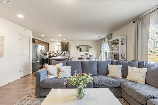 12810 NE 118th Way, Vancouver, WA 98682 - living room featuring light wood-style floors, recessed lighting, and baseboards