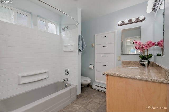 full bathroom with vanity, toilet, tiled shower / bath, and a baseboard radiator