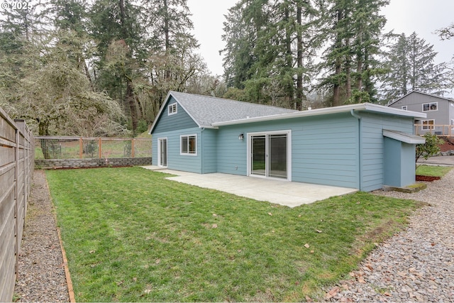 back of house featuring a yard and a patio area