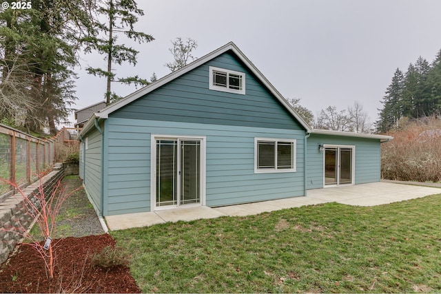 rear view of property with a patio area and a lawn