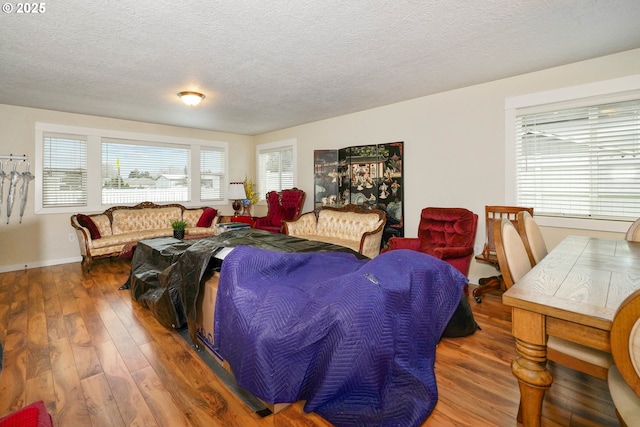 living area with a textured ceiling and dark wood-type flooring