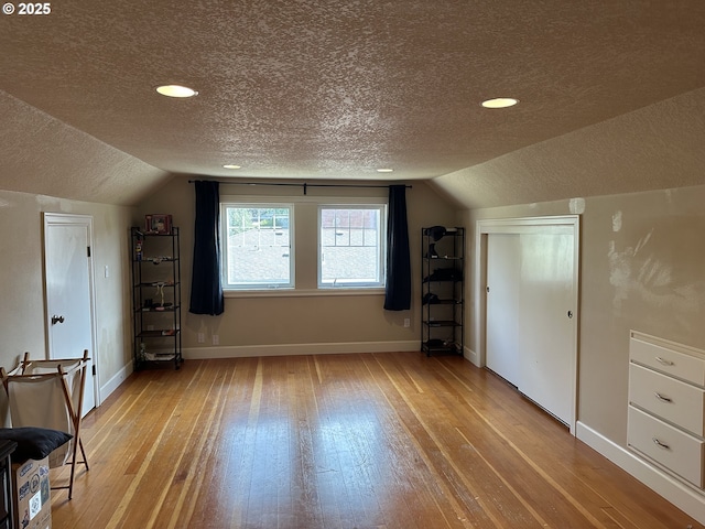 4523 NE 105th Ave, Portland, OR 97220 - additional living space with a textured ceiling, vaulted ceiling, light wood-type flooring, and recessed lighting