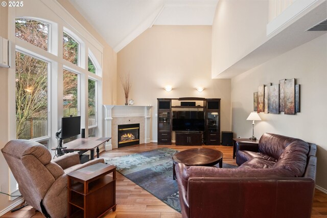 entryway with light hardwood / wood-style floors, a chandelier, and a high ceiling