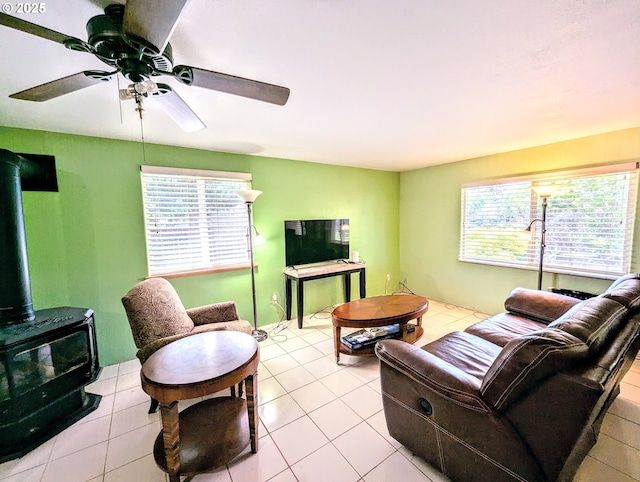 713 N 9th Ave, Elgin, OR 97827 - living area featuring a wood stove, light tile patterned floors, and a ceiling fan