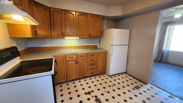 kitchen featuring white fridge and electric range oven