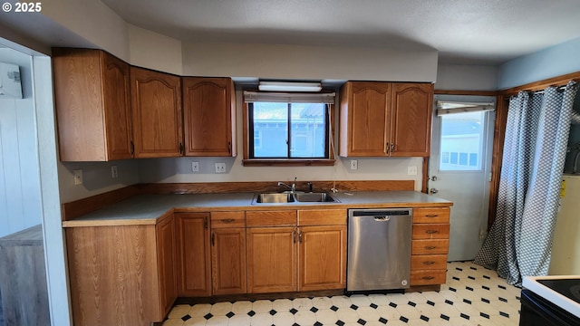 kitchen featuring range with electric cooktop, dishwasher, and sink