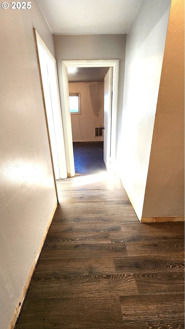 hallway with dark hardwood / wood-style flooring