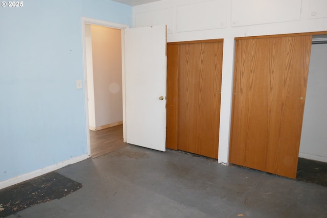 unfurnished bedroom with multiple closets