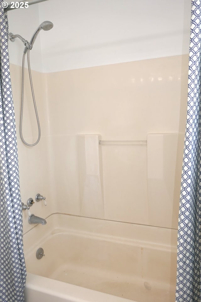 bathroom with shower / tub combo with curtain