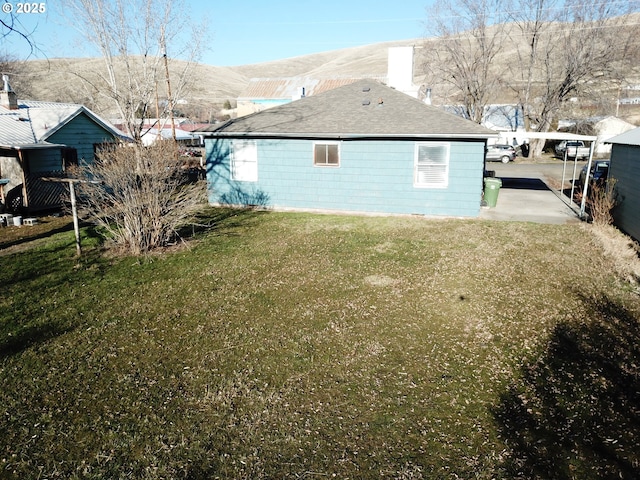 view of side of home with a yard